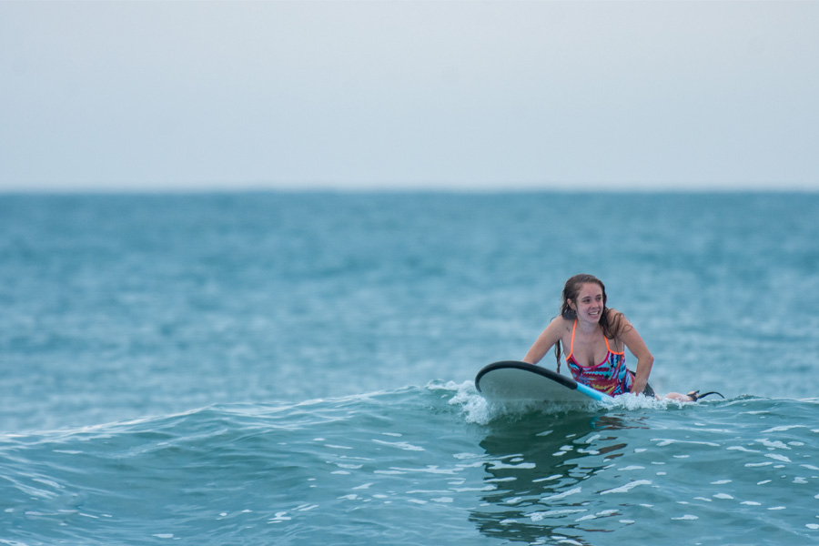 A girl surfing amidst the waves of Arugam Bay