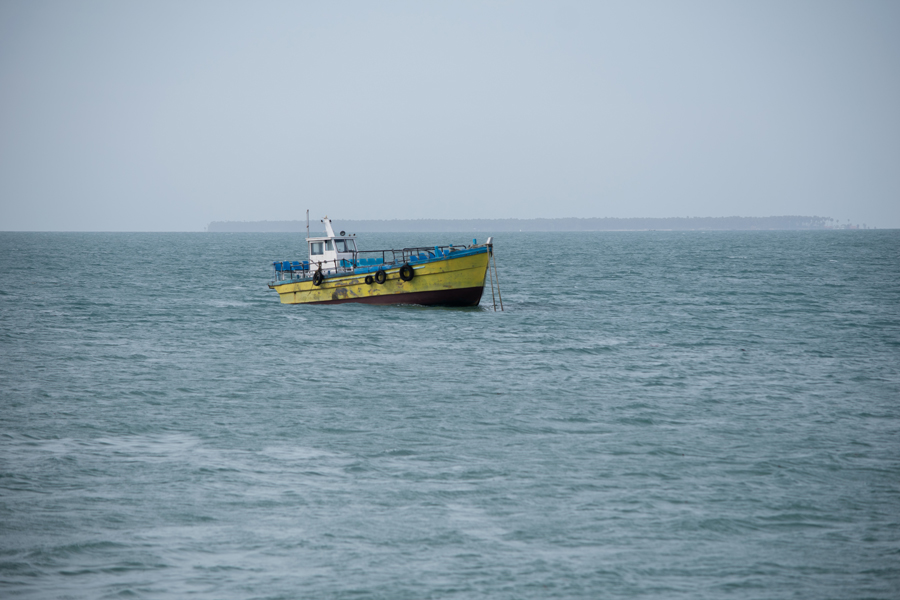 A blue colour boat sailing on the ocean of Jaffna