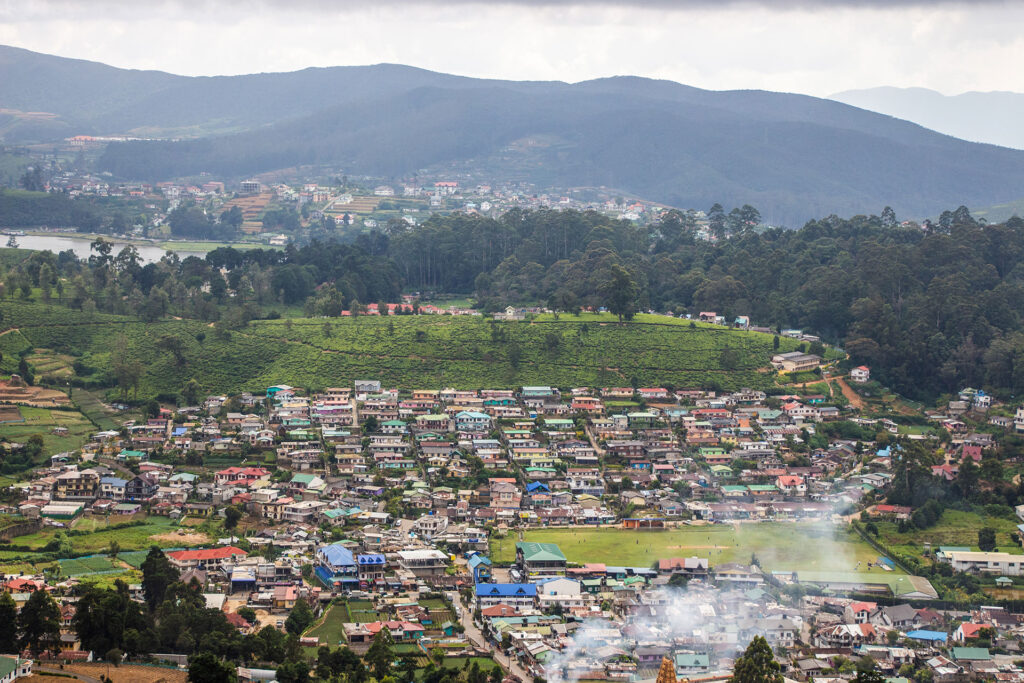 A group of houses nestled in a mountainous area captured from a high place