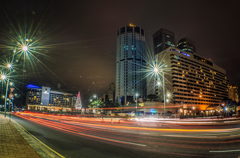 A night view of the illuminated tall buildings by the roads of Colombo, Sri Lanka