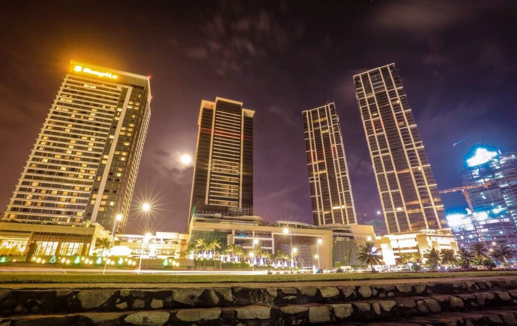 Four tall buildings lighted at night