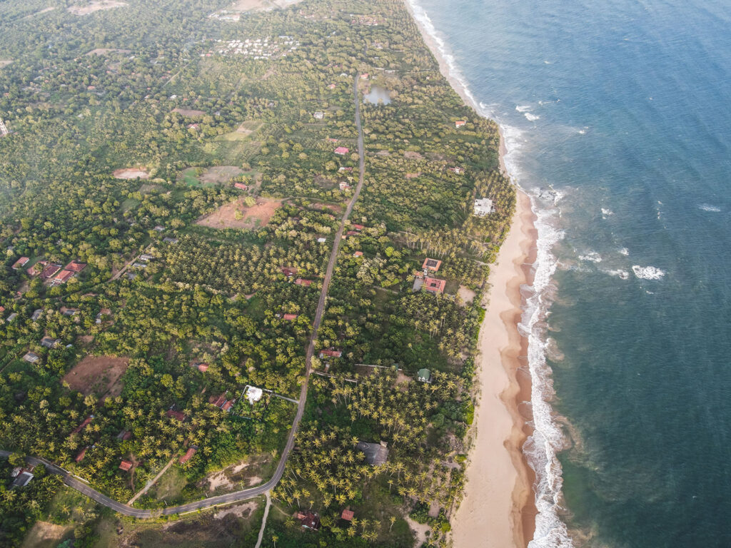 Sky view of a beach and a verdant area