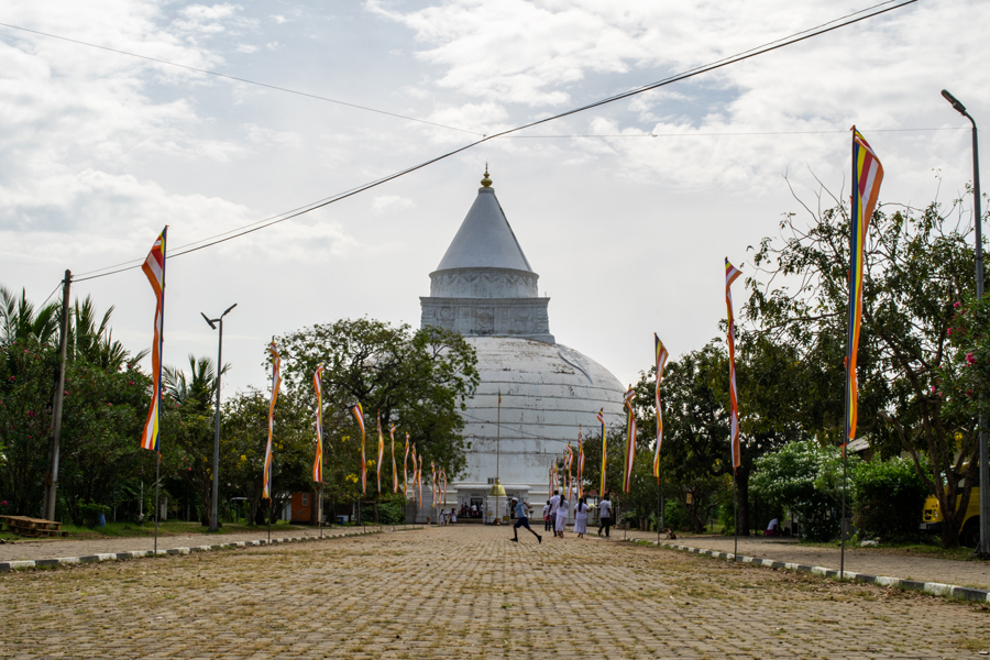 The large white stupa of Thissamaharama Raja Maha Viharaya in Sri Lanka and the path that leads to it
