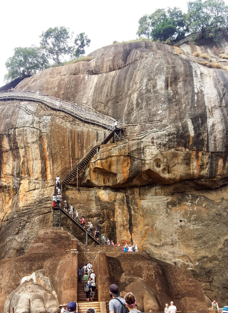 The rock fortress of Sigiriya with people on its stairway