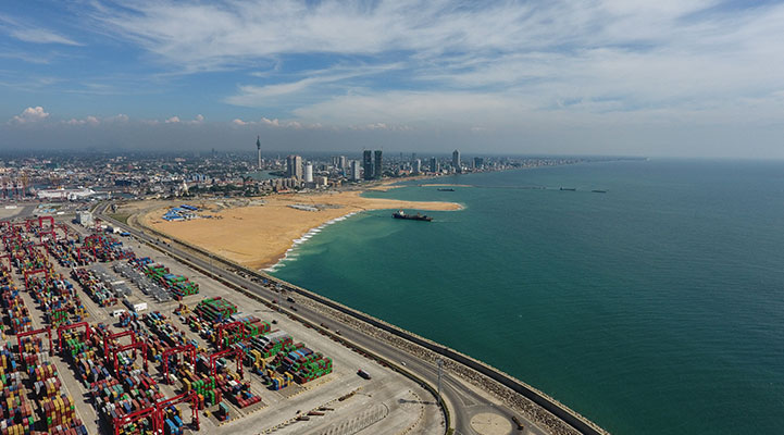 Colombo Port City coming up by the waves of the Sri Lankan sea.