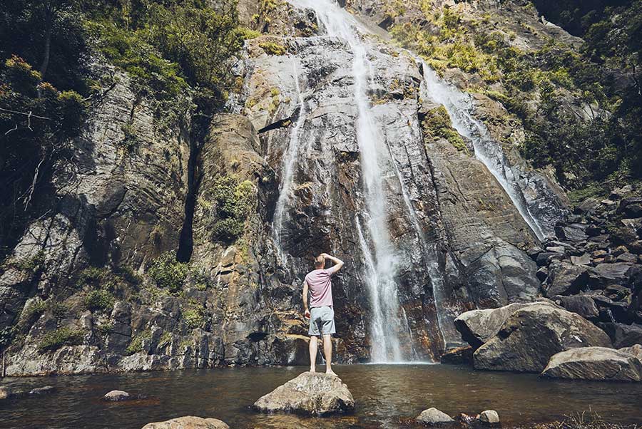 A traveler infront of the Bambarakanda, the Wonderful Waterfall of Sri Lanka