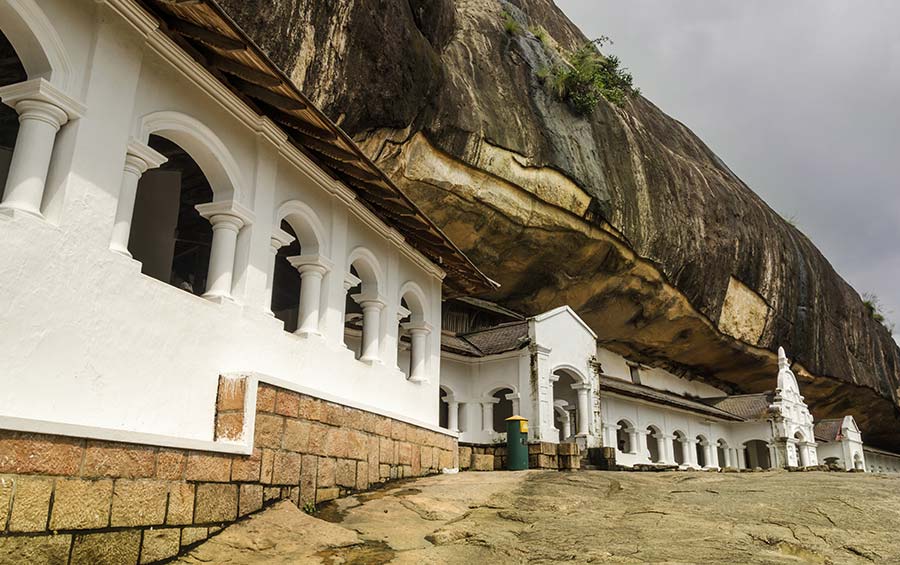 The Dambulla Temple Cave Complex in Sri Lanka along with the white ancient buildings of the temple
