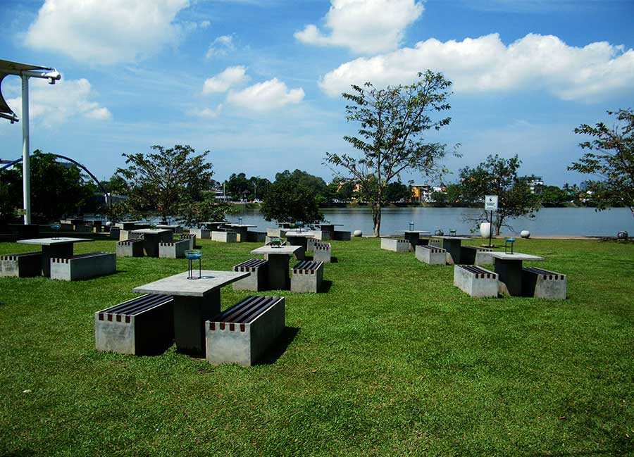 The lake, the lawn, and the benches of Diyatha Uyana, one of the best parks in Sri Lanka