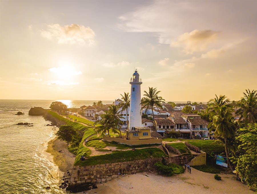 The white lighthouse, ocean, shores, and the Galle Fort