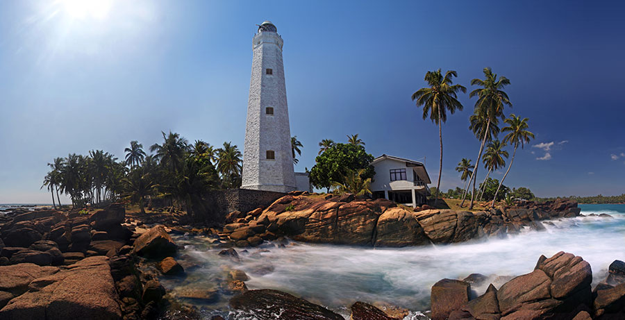 Visiting the Dondra lighthouse with the ocean, rocks, beach on its surroundings is one of the best things to do at Matara, Sri Lanka