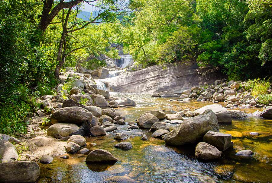 A water stream flowing through the rocks and the greenery at Meemure, Sri Lanka