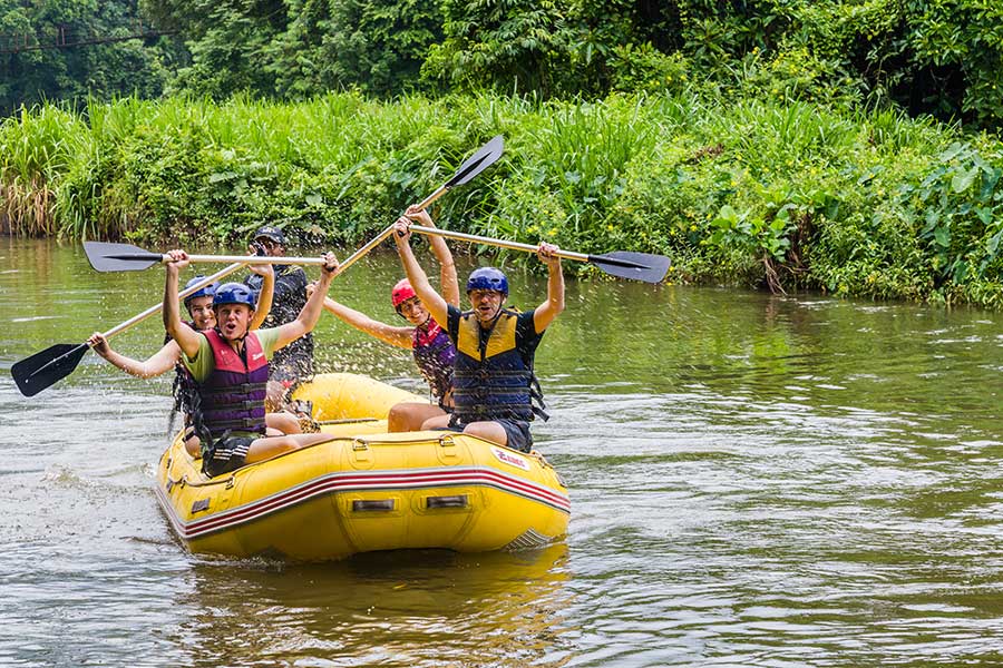 A group of men, White Water Rafting in a water way at Kitulgala