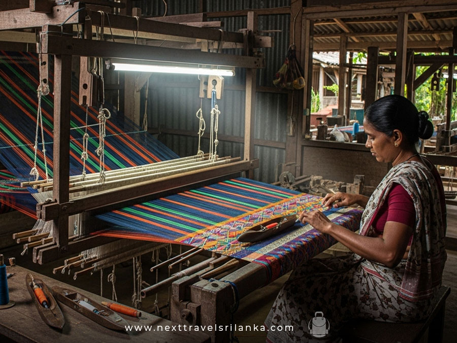 A colourful handloom in the process of making, with a handloom weaving machine, signifying the beauty of the Handloom Industry in Sri Lanka