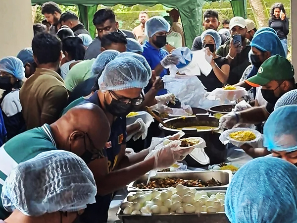 Community members preparing meals at a relief kitchen after Cyclone Ditwah.