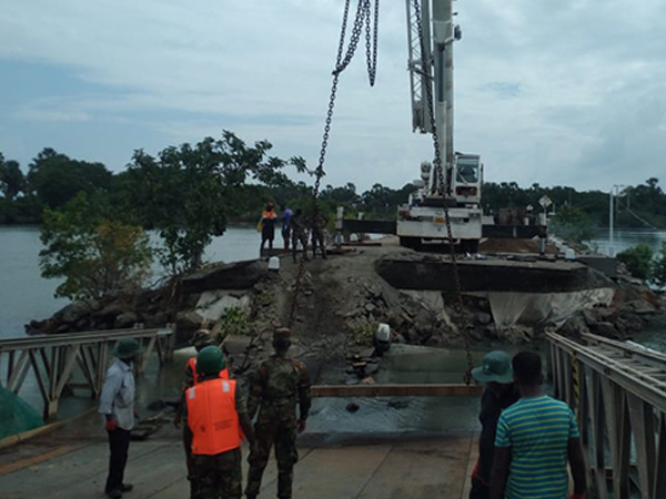 Damaged road and bridge infrastructure due to flooding and landslides in Sri Lanka.