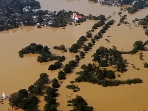 Overflowing river flooding nearby settlements along major rivers in Sri Lanka.